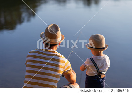 Dad teaching his little boy how to fish by the lake 126606246