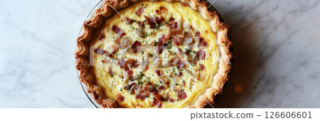 Freshly baked Quiche Lorraine showcases a flaky crust filled with a rich mixture of eggs, cream, and crispy bacon. Perfect for brunch or any meal, banner Freshly baked Quiche Lorraine showcases a flaky crust filled with a rich mixture of eggs, cream, and crispy bacon. Perfect for brunch or any meal, banner 126606601
