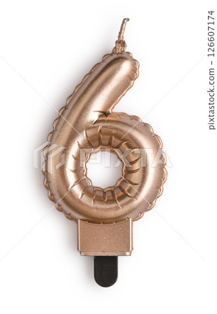 Golden cake candle in shape of number six Golden cake candle in shape of number six 126607174