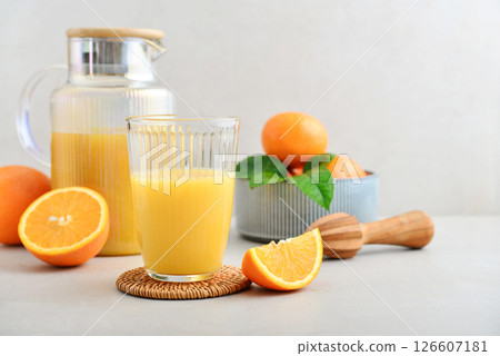 Orange fresh squeezed juice in glass and glasses jug 126607181