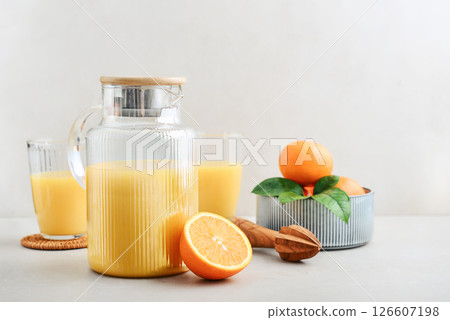 Orange fresh squeezed juice in glass and glasses jug Orange fresh squeezed juice in glass and glasses jug 126607198