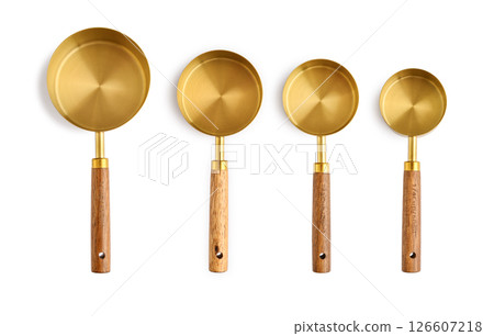 Golden measuring spoons with wooden handles 126607218