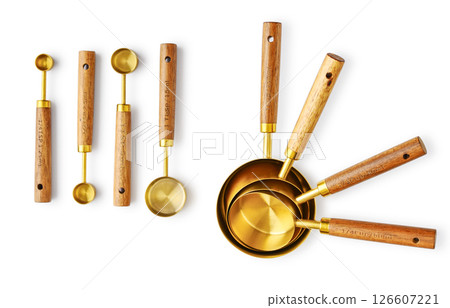 Golden measuring spoons with wooden handles 126607221