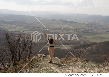 Mountains Woman Nature: Woman celebrates mountain top view during daytime, feeling freedom, happiness. Mountains Woman Nature: Woman celebrates mountain top view during daytime, feeling freedom, happiness. 126607565