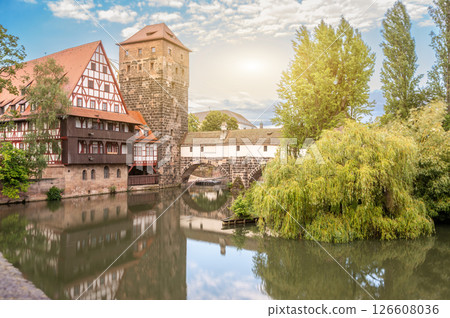 Nuremberg, Germany, August 2, 2023. Beautiful shot with an iconic image of the fairytale atmosphere of the place. On the beautiful summer day the half-timbered house is reflected in the water. Nuremberg, Germany, August 2, 2023. Beautiful shot with an iconic image of the fairytale atmosphere of the place. On the beautiful summer day the half-timbered house is reflected in the water. 126608036