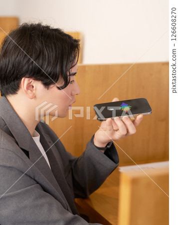 A businessman talking to a voice recognition AI 126608270