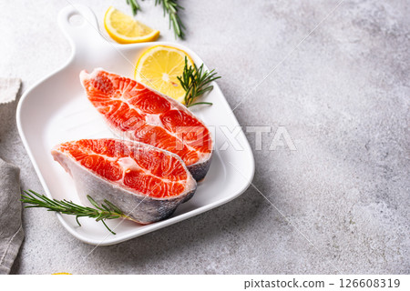 Raw uncooked salmon with rosemary Raw uncooked salmon with rosemary 126608319