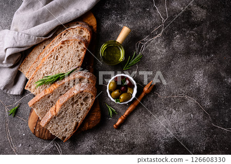 Fresh bread, olive oil and mix of olives. 126608330
