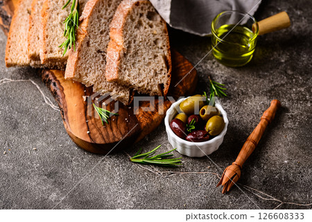 Fresh bread, olive oil and mix of olives. 126608333