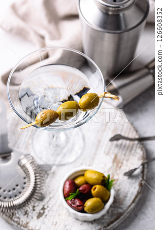 Traditional martini cocktail with olives and Traditional martini cocktail with olives and 126608352
