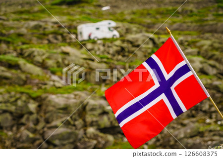 Norwegian flag and camper car in mountains Norwegian flag and camper car in mountains 126608375