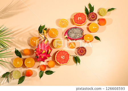 Fruity sunny banner. Summer in a snapshot, oranges, dragon fruit, apricots, pitaya, grapefruit on a bright background with shadows from a palm tree, Tropical background with exotic fruits, template Fruity sunny banner. Summer in a snapshot, oranges, dragon fruit, apricots, pitaya, grapefruit on a bright background with shadows from a palm tree, Tropical background with exotic fruits, template 126608593