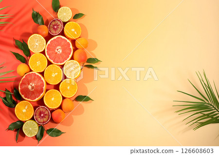 Fruity sunny banner. Summer in a snapshot, oranges, apricots, lemons, grapefruit on a bright background with shadows from a palm tree, Tropical background with exotic fruits, template for your design. Fruity sunny banner. Summer in a snapshot, oranges, apricots, lemons, grapefruit on a bright background with shadows from a palm tree, Tropical background with exotic fruits, template for your design. 126608603