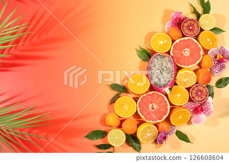 Fruity sunny banner. Summer in a snapshot, oranges, dragon fruit, apricots, pitaya, grapefruit on a bright background with shadows from a palm tree, Tropical background with exotic fruits, template Fruity sunny banner. Summer in a snapshot, oranges, dragon fruit, apricots, pitaya, grapefruit on a bright background with shadows from a palm tree, Tropical background with exotic fruits, template 126608604