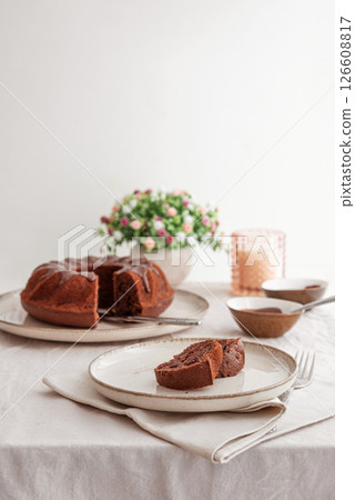 Chocolate cake with chocolate icing on white wooden table. Front view Chocolate cake with chocolate icing on white wooden table. Front view 126608817