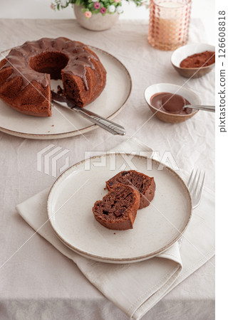 Chocolate cake with chocolate icing on white wooden table. Top view 126608818