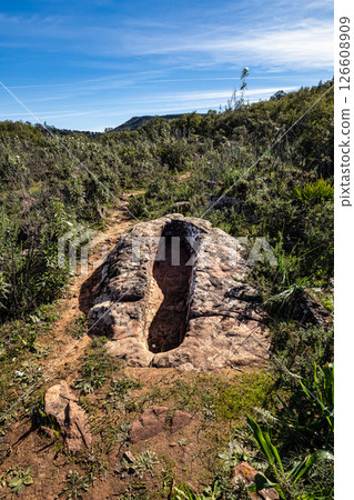Granite rock cut anthropomorphic grave in Vale Fuzeiros at Vilarinha, Algarve, Portugal. Granite rock cut anthropomorphic grave in Vale Fuzeiros at Vilarinha, Algarve, Portugal. 126608909