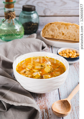 Fresh chicken soup with vegetables in a bowl on the table vertical view Fresh chicken soup with vegetables in a bowl on the table vertical view 126608977