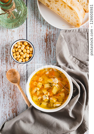 A bowl of soup with chicken broth, vegetables and pasta top and vertical view A bowl of soup with chicken broth, vegetables and pasta top and vertical view 126608981