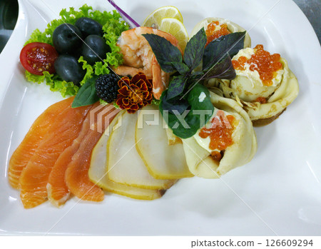 A delicious fish platter on a large white plate 126609294