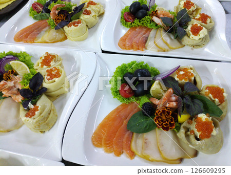A delicious fish platter on a large white plate A delicious fish platter on a large white plate 126609295