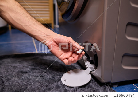 Repairing a Washing Machine Hose Connection at Home Requires Handy Skills and Tools 126609484