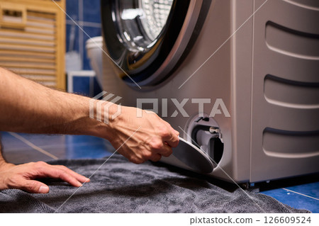 Repairing a Washing Machine Hose Connection at Home Requires Handy Skills and Tools 126609524