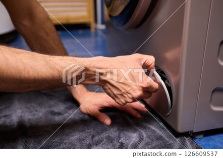 Repairing a Washing Machine Hose Connection at Home Requires Handy Skills and Tools 126609537