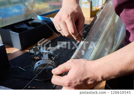 Hands actively engaged in working on advanced technology with various modern gadgets and devices 126610545