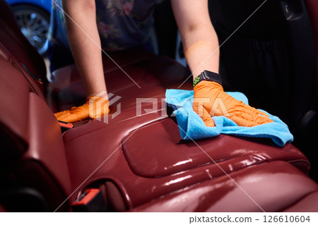 Cleaning a Luxury Car Seat with a Detail Brush and Foam for Maintaining Its Appearance Cleaning a Luxury Car Seat with a Detail Brush and Foam for Maintaining Its Appearance 126610604