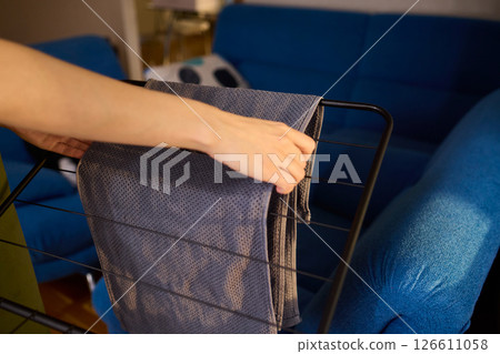 Arranging Freshly Laundered Towels Neatly on a Drying Rack for Optimal Drying and Organization Arranging Freshly Laundered Towels Neatly on a Drying Rack for Optimal Drying and Organization 126611058