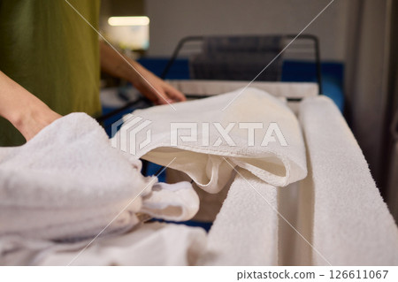 Arranging Freshly Laundered Towels Neatly on a Drying Rack for Optimal Drying and Organization Arranging Freshly Laundered Towels Neatly on a Drying Rack for Optimal Drying and Organization 126611067