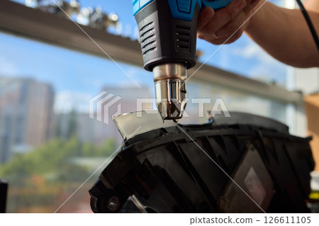 Careful precision is essential when installing a car headlight assembly for optimal performance 126611105