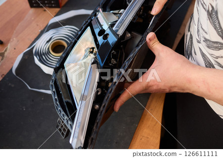 Careful precision is essential when installing a car headlight assembly for optimal performance 126611111