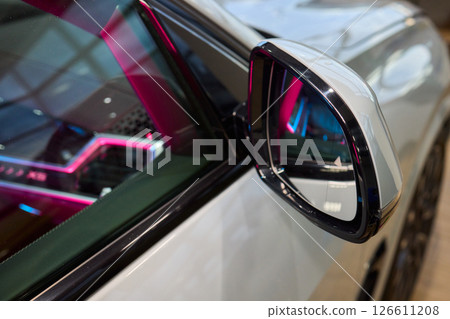 An elegant closeup shot of a sleek car side mirror showcasing its design and details An elegant closeup shot of a sleek car side mirror showcasing its design and details 126611208