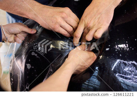 Applying a Protective Film on the Surface of Your Car for Enhanced Durability and Shine 126611221