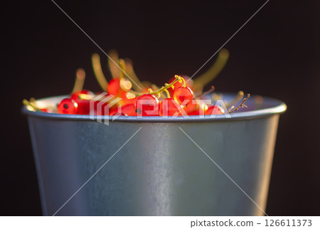 Ripe red currant berries in a cup. Ripe red currant berries in a cup. 126611373
