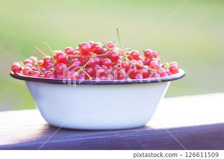 Ripe red currant berries in a cup. Ripe red currant berries in a cup. 126611509