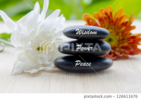 Wisdom, Power and Peace text on zen stones with blooming flowers Wisdom, Power and Peace text on zen stones with blooming flowers 126611676