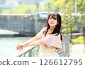 Woman looking at camera on promenade 126612795