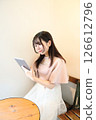 A woman who operates a tablet 126612796