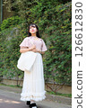 Woman walking on the pavement 126612830