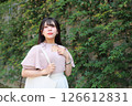 Woman walking on the pavement 126612831