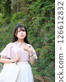 Woman walking on the pavement 126612832
