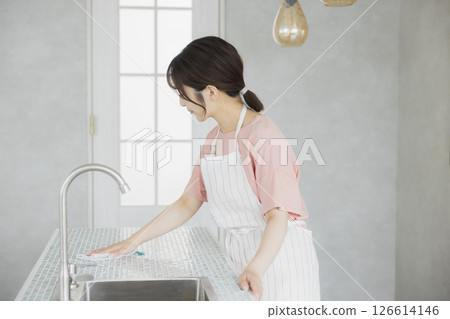 A woman doing housework in the kitchen 126614146