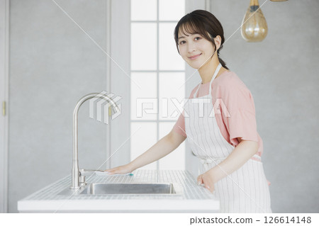 A woman doing housework in the kitchen 126614148