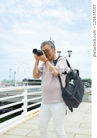 Senior male shooting with camera 126614507