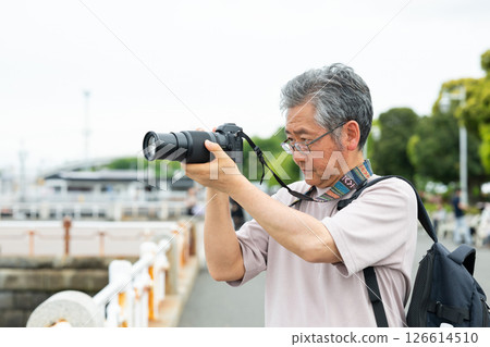 Senior male shooting with camera 126614510