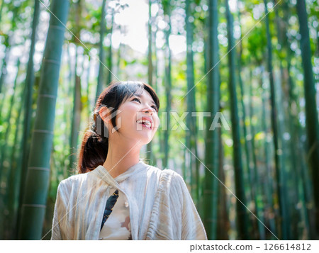 Woman looking at bamboo forest 126614812