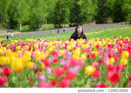 A young woman sightseeing in a tulip field 126614980